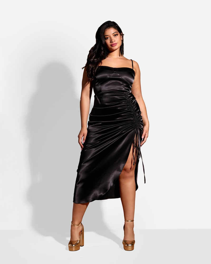 Front of a model wearing a size 2X Mina Satin Adjustable Ruched Midi Bodycon Dress in Black by Rebdolls. | dia_product_style_image_id:324483